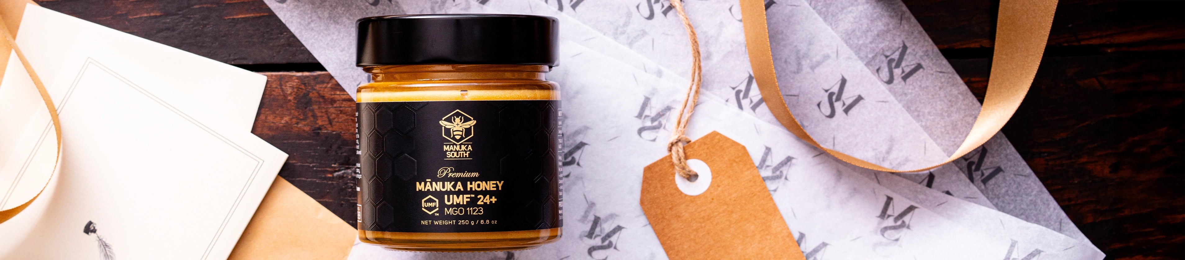 Jar of honey with a black lid on a wooden surface