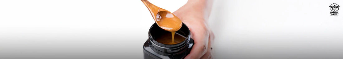 A spoon drizzling thick Manuka honey from a jar, highlighting the rich texture and quality difference in the Manuka Honey vs. Regular Honey comparison.