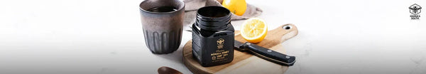 Jar of Manuka honey on a wooden board with a lemon and a cup, for a guide to manuka honey by MGO rating