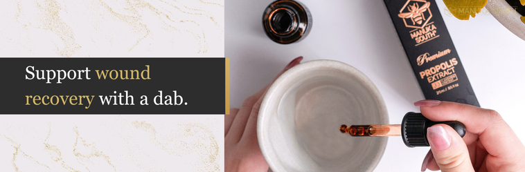 Hand holding a small container with a dropper applying a liquid to it, on a white background.
