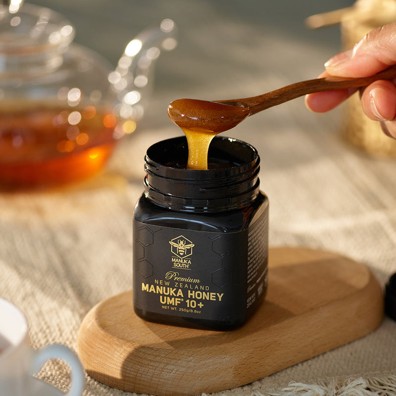 Detailed view of UMF 10+ Manuka Honey poured into jar by spoon