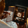 an old person holding a manuka honey set