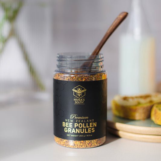 wooden spoon in a bottle of bee pollen granules
