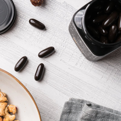 Black Propolis Capsules on Table