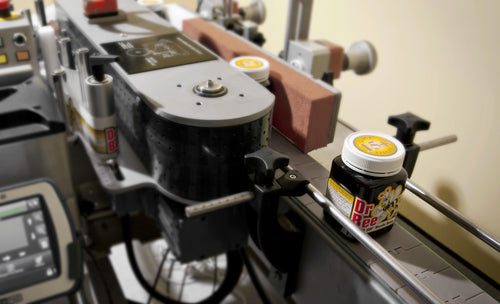 Dr. Bee Manuka Honey jar on packaging and labelling machine