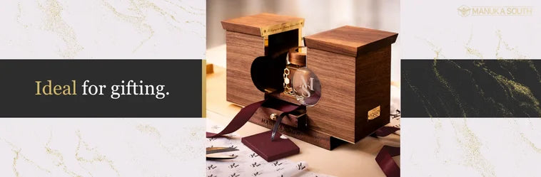 Elegant Manuka South honey gift set with a bottle in a premium wooden box.