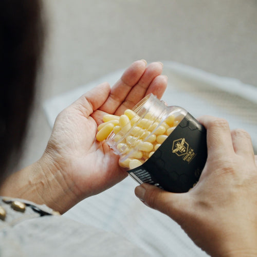 Royal Jelly Capsules pouring into hand