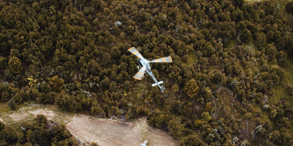 chopper flying over a field