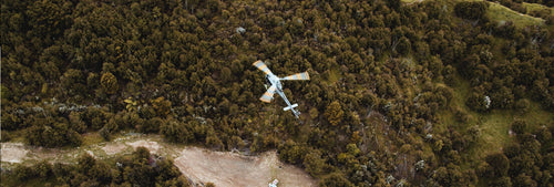 chopper flying over a field